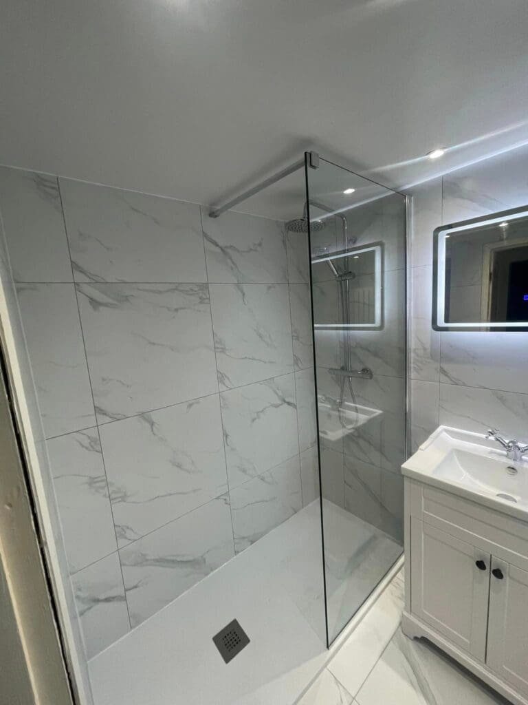 Stylish tiled bathroom with basin vanity unit and shower – quality tiling and plumbing in Sunderland.